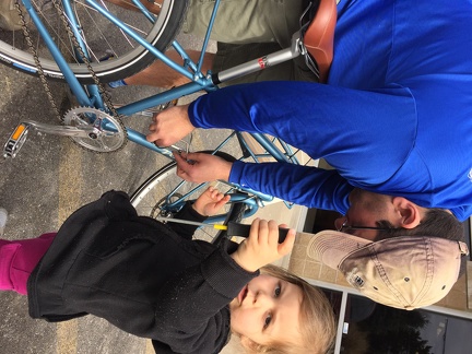Helping daddy put a bottle cage on mommy s bike3